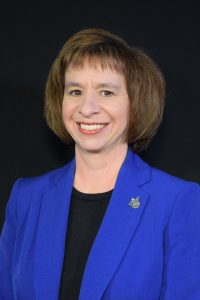 Headshot of Dr. Amy Harrell with black background. 